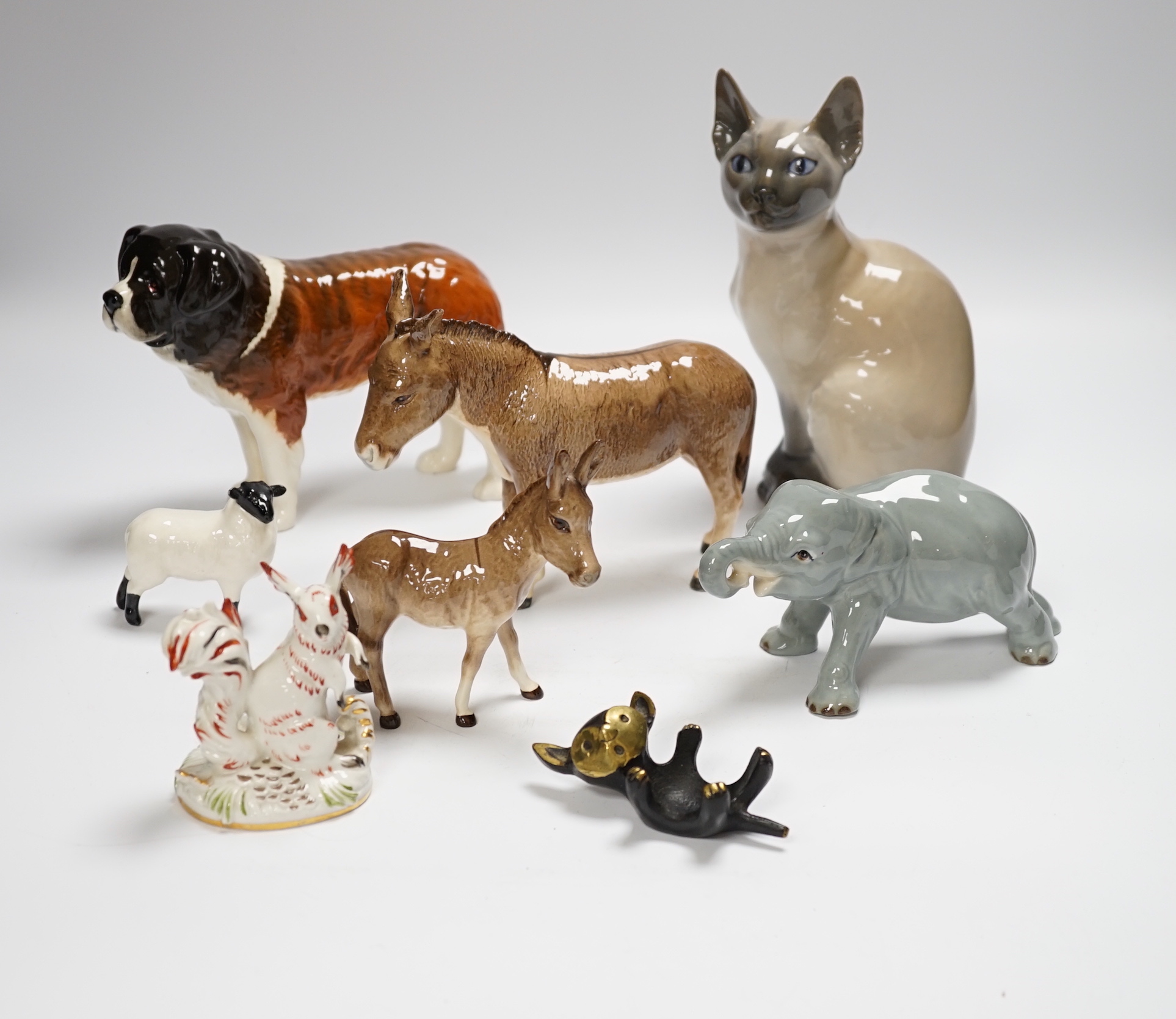 Eight animals including four Beswick, a Szeiler, a Royal Copenhagen, a cast metal cat and a Schierhols and Sohn, tallest 19.5cm